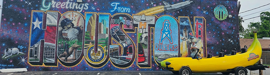 A photo of a "Greetings From" style mural of Houston Texas.